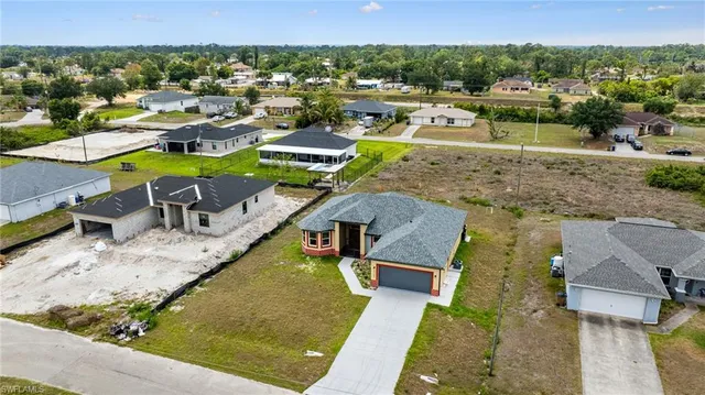 an aerial view of a house with a swimming pool yard and outdoor seating