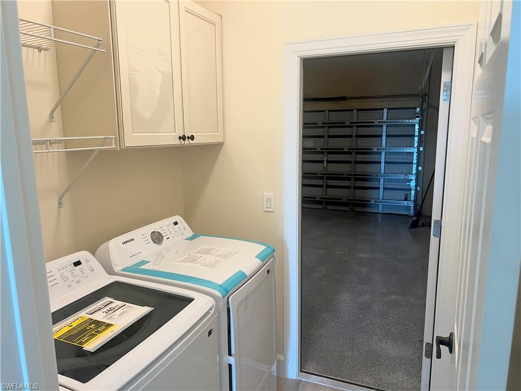 4909 Berryman Street Lehigh Acres, FL 33971 - Photo 29 of 30 Laundry room featuring cabinet space and separate washer and dryer