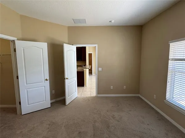 an empty room with windows and closet