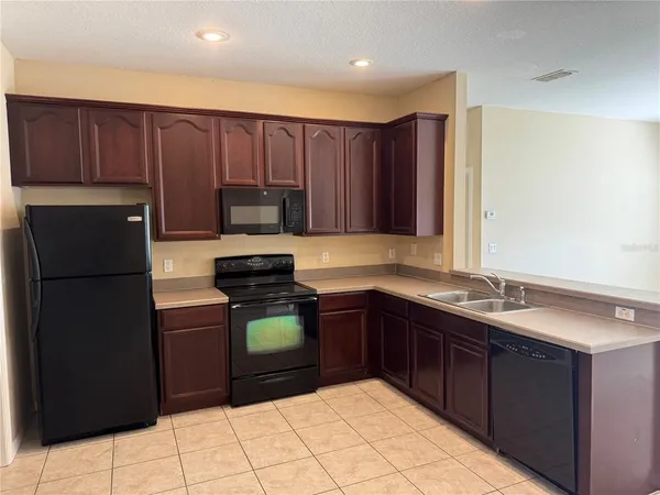 a kitchen with a sink and a stove top oven