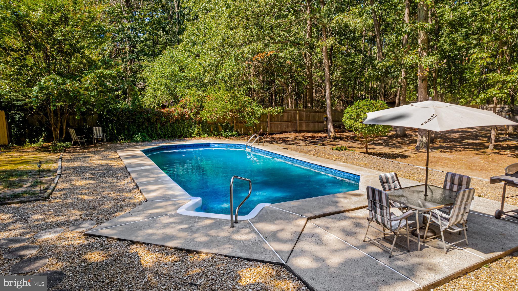 4 Oak Leaf Road Berlin, NJ 08009 - Photo 5 of 18 a view of swimming pool with table and chairs under an umbrella