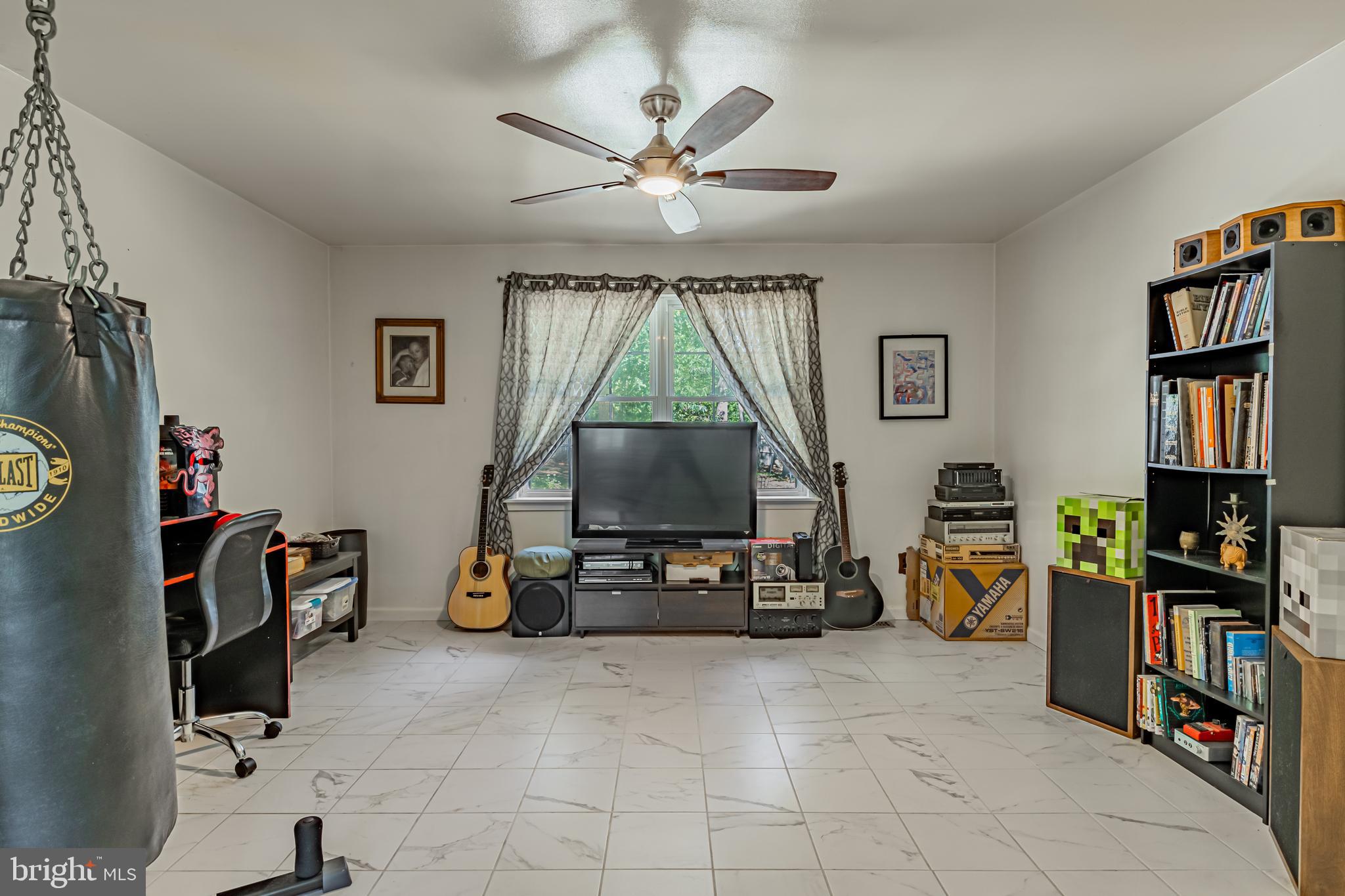 4 Oak Leaf Road Berlin, NJ 08009 - Photo 10 of 18 a living room with furniture a window and a flat screen tv