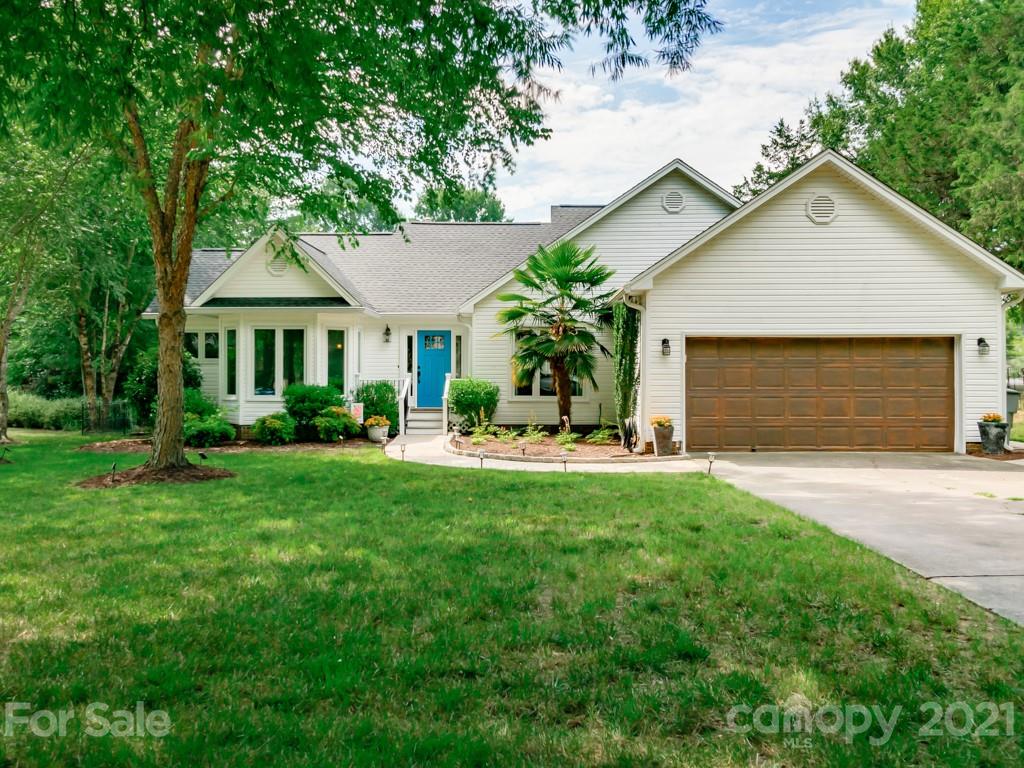 3337 Thaxton Place Charlotte, NC 28226 - Photo 1 of 36 a front view of a house with a yard and garage