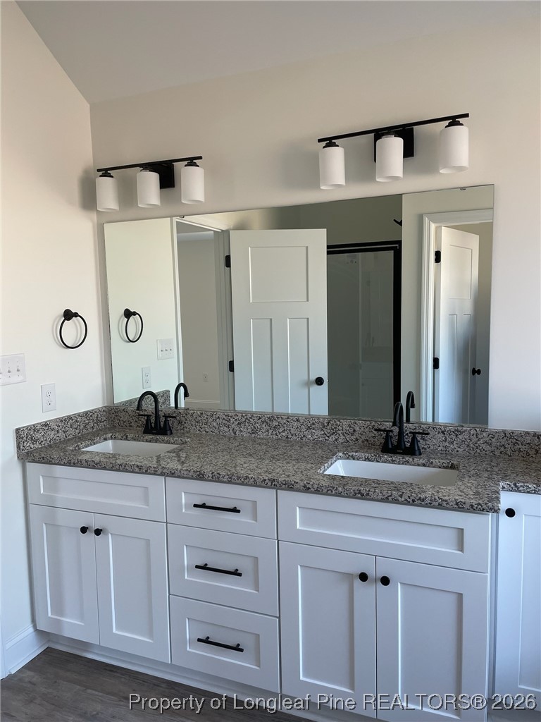209 August Lane Raeford, NC 28376 - Photo 13 of 20 a bathroom with a granite countertop sink and a mirror