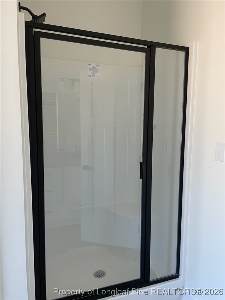 209 August Lane Raeford, NC 28376 - Photo 15 of 20 a bathroom with a glass shower door