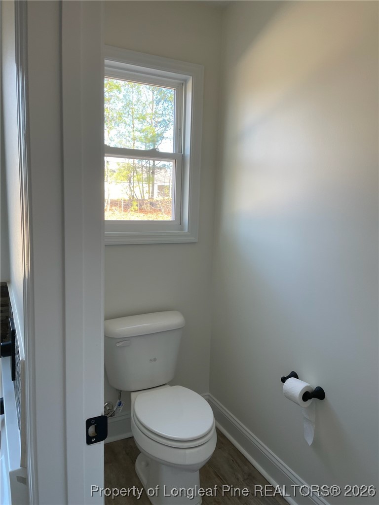 209 August Lane Raeford, NC 28376 - Photo 16 of 20 a white toilet sitting in a bathroom next to a window