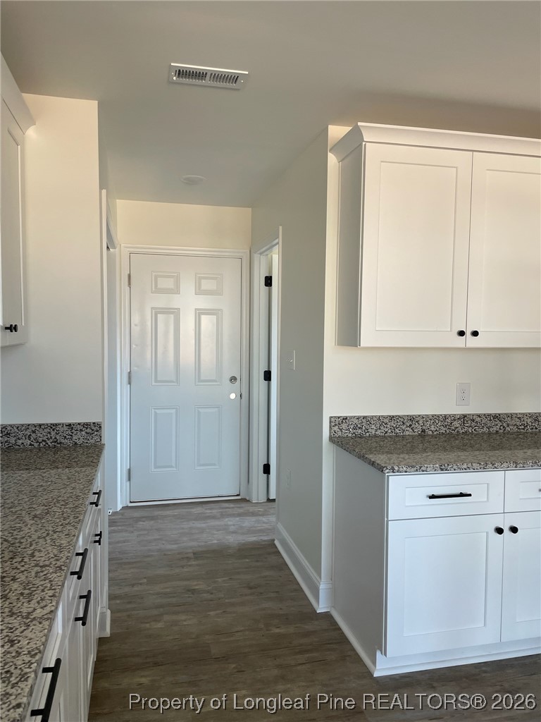 209 August Lane Raeford, NC 28376 - Photo 8 of 20 view of kitchen with granite countertop cabinets and wooden floor