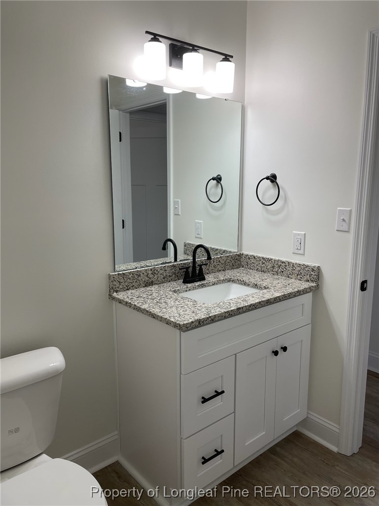 209 August Lane Raeford, NC 28376 - Photo 9 of 20 a bathroom with a granite countertop sink and a toilet