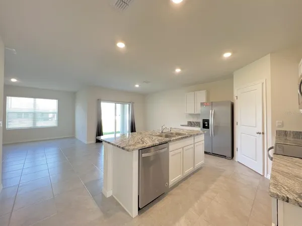 a kitchen with stainless steel appliances granite countertop a sink and a stove