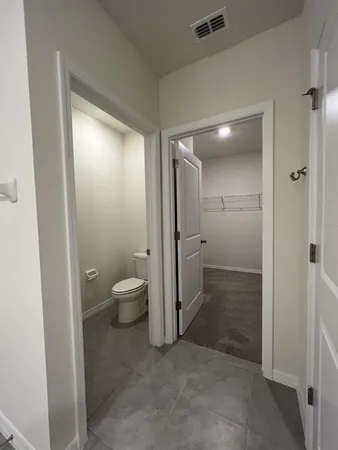a bathroom with a granite countertop sink mirror and toilet