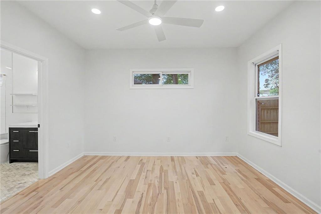 827 Elbert Street Southwest Atlanta, GA 30310 - Photo 17 of 33 an empty room with wooden floor and windows