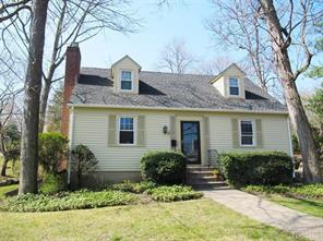 a front view of house with yard and trees around