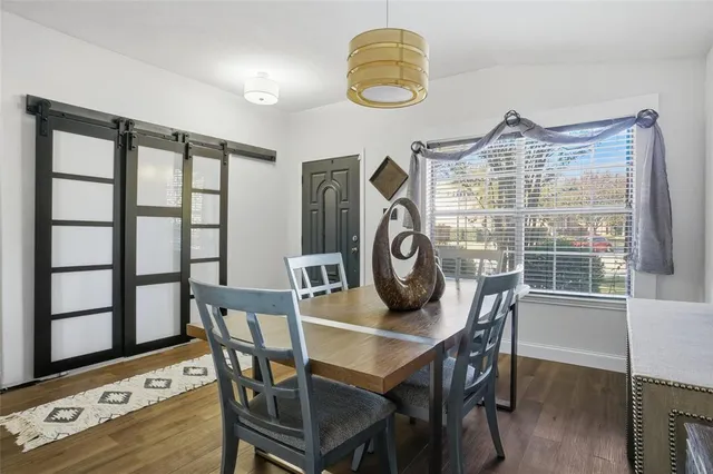 a view of a dining room with furniture and window