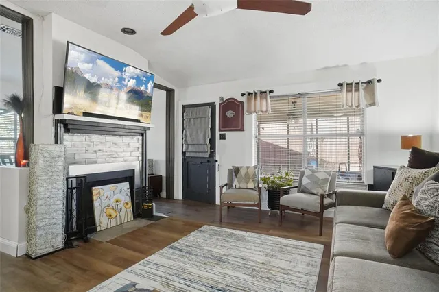 a living room with furniture a fireplace and a flat screen tv