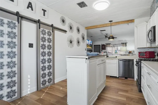 a kitchen with cabinets and stainless steel appliances