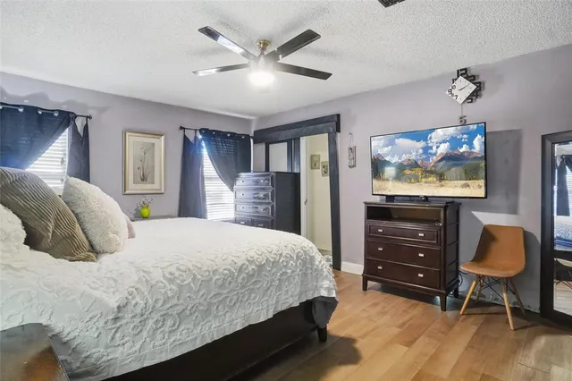 a bedroom with a bed window and dresser