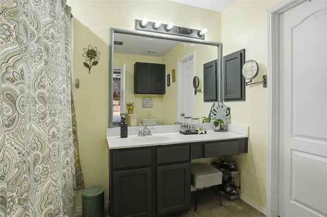 a bathroom with a double vanity sink mirror and