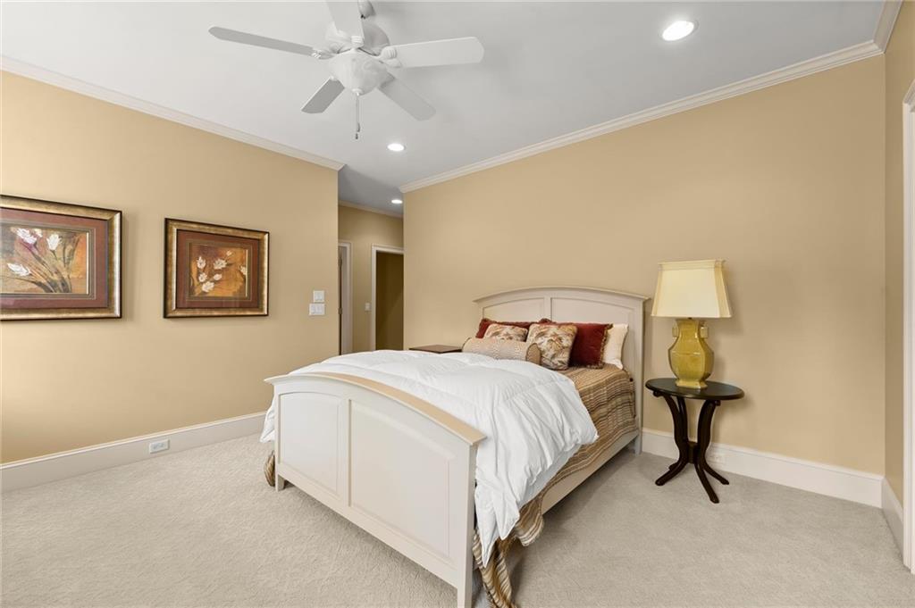 322 Edwards Brook Lane Canton, GA 30115 - Photo 60 of 99 a bedroom with a bed and a chandelier