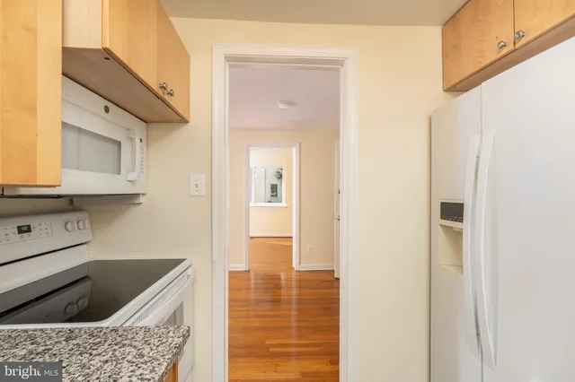 a kitchen with granite countertop a sink and cabinets
