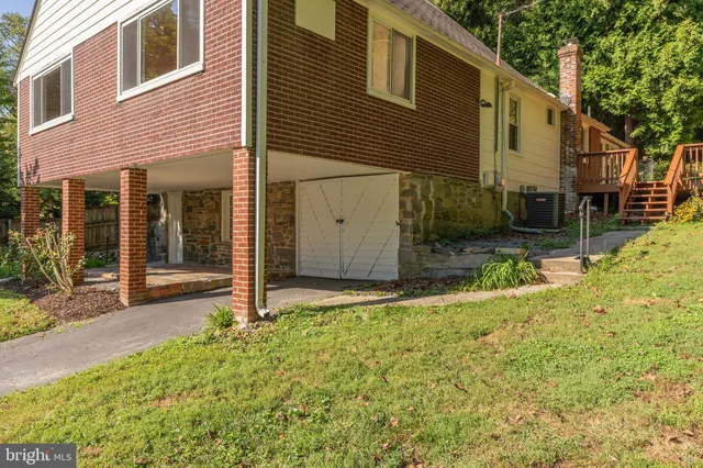 a backyard of a house with yard and outdoor seating