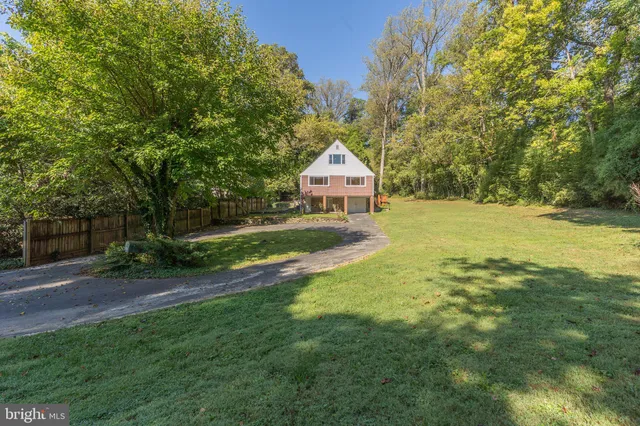 a view of backyard of house with green space