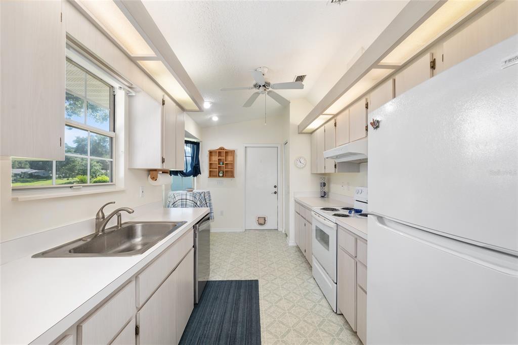 8038 Southwest 108th Loop Ocala, FL 34481 - Photo 11 of 48 a kitchen with a sink stove top oven and cabinets