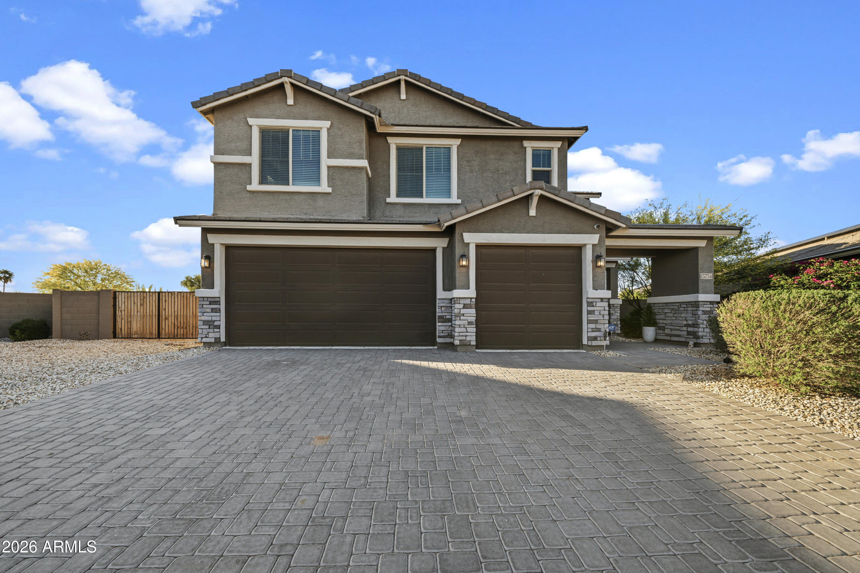 15754 West Madison Street Goodyear, AZ 85338 - Photo 1 of 35 a front view of a house with a yard and garage