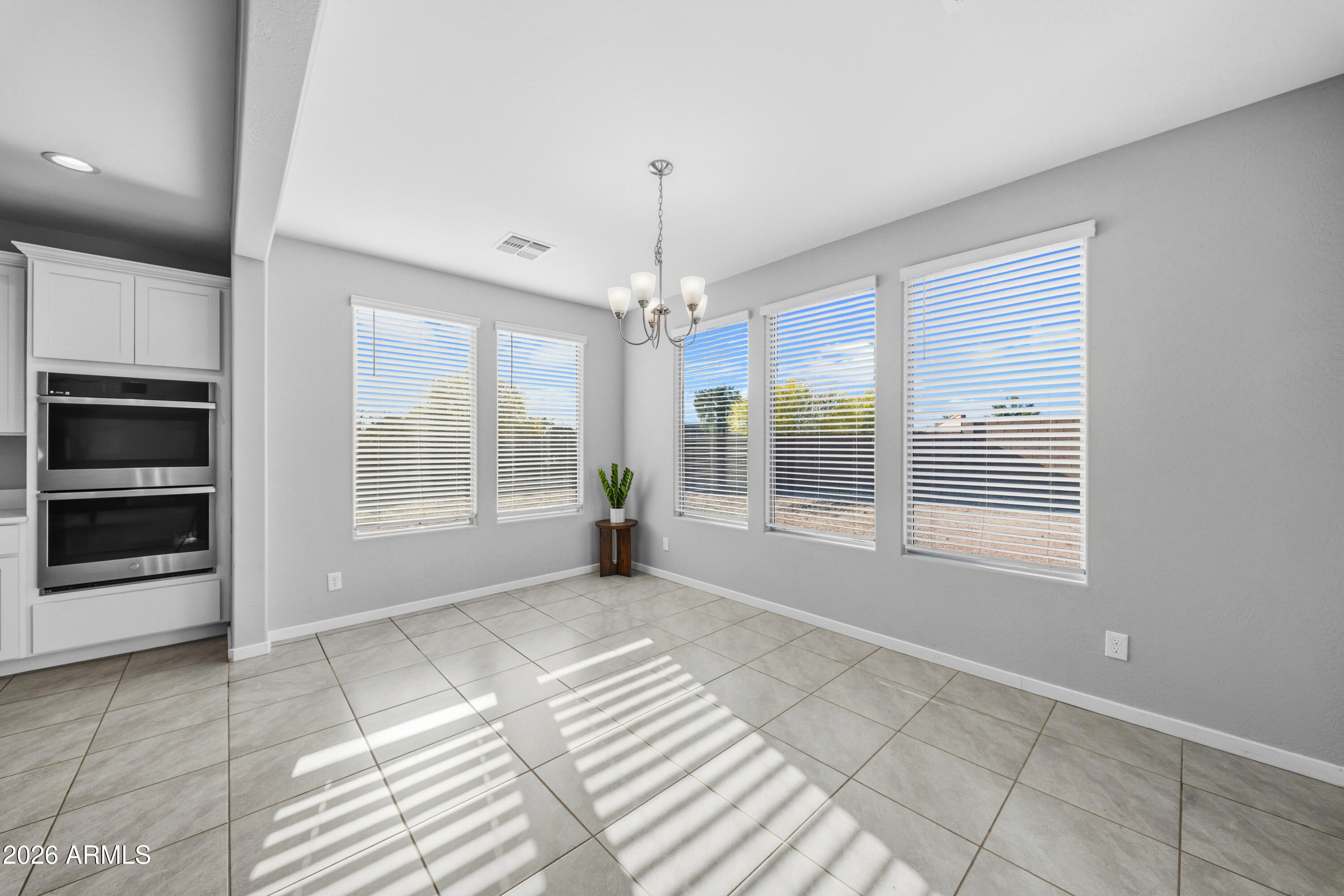 15754 West Madison Street Goodyear, AZ 85338 - Photo 11 of 35 a view of an empty room with a window and fire place