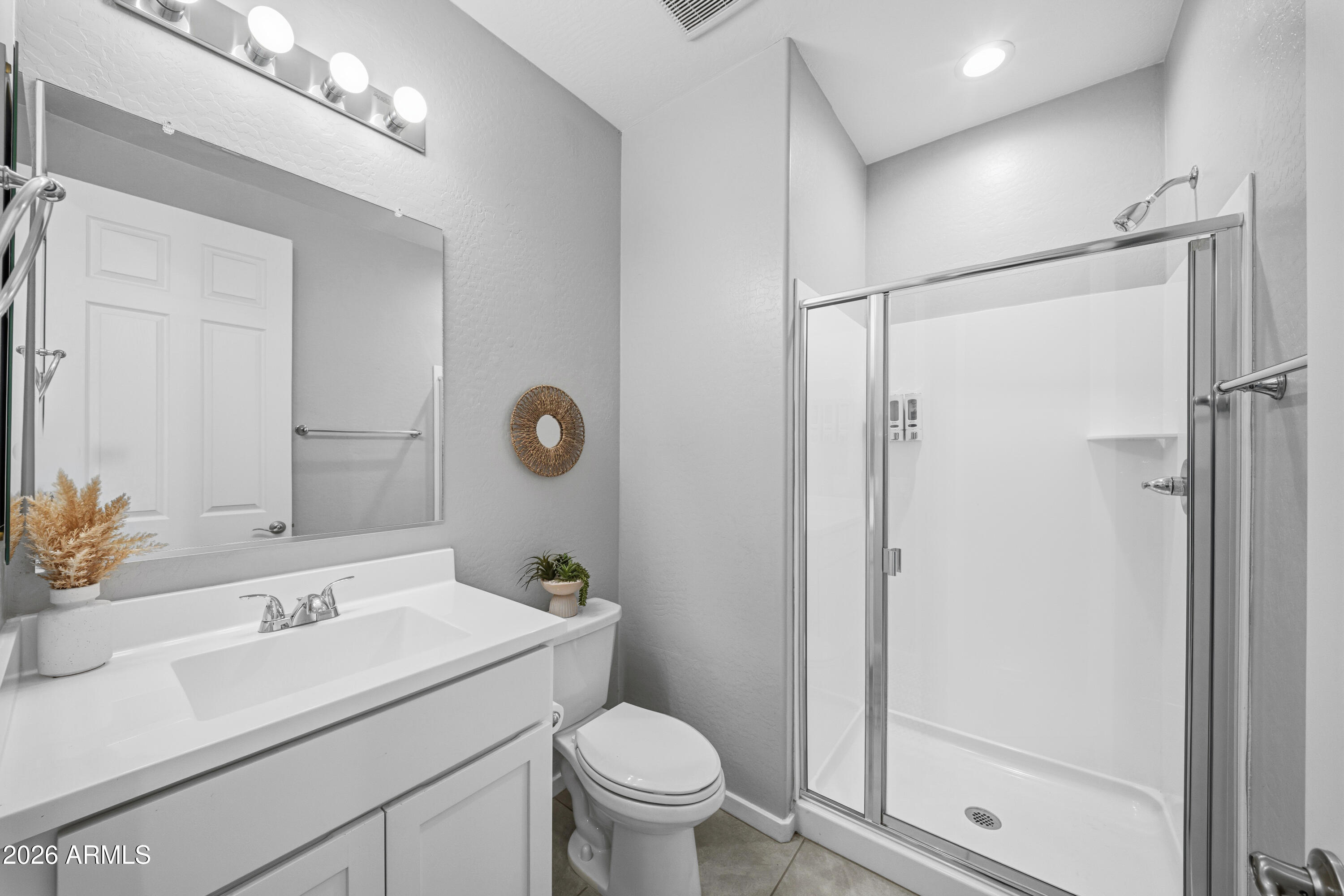 15754 West Madison Street Goodyear, AZ 85338 - Photo 31 of 35 a bathroom with a sink toilet and shower