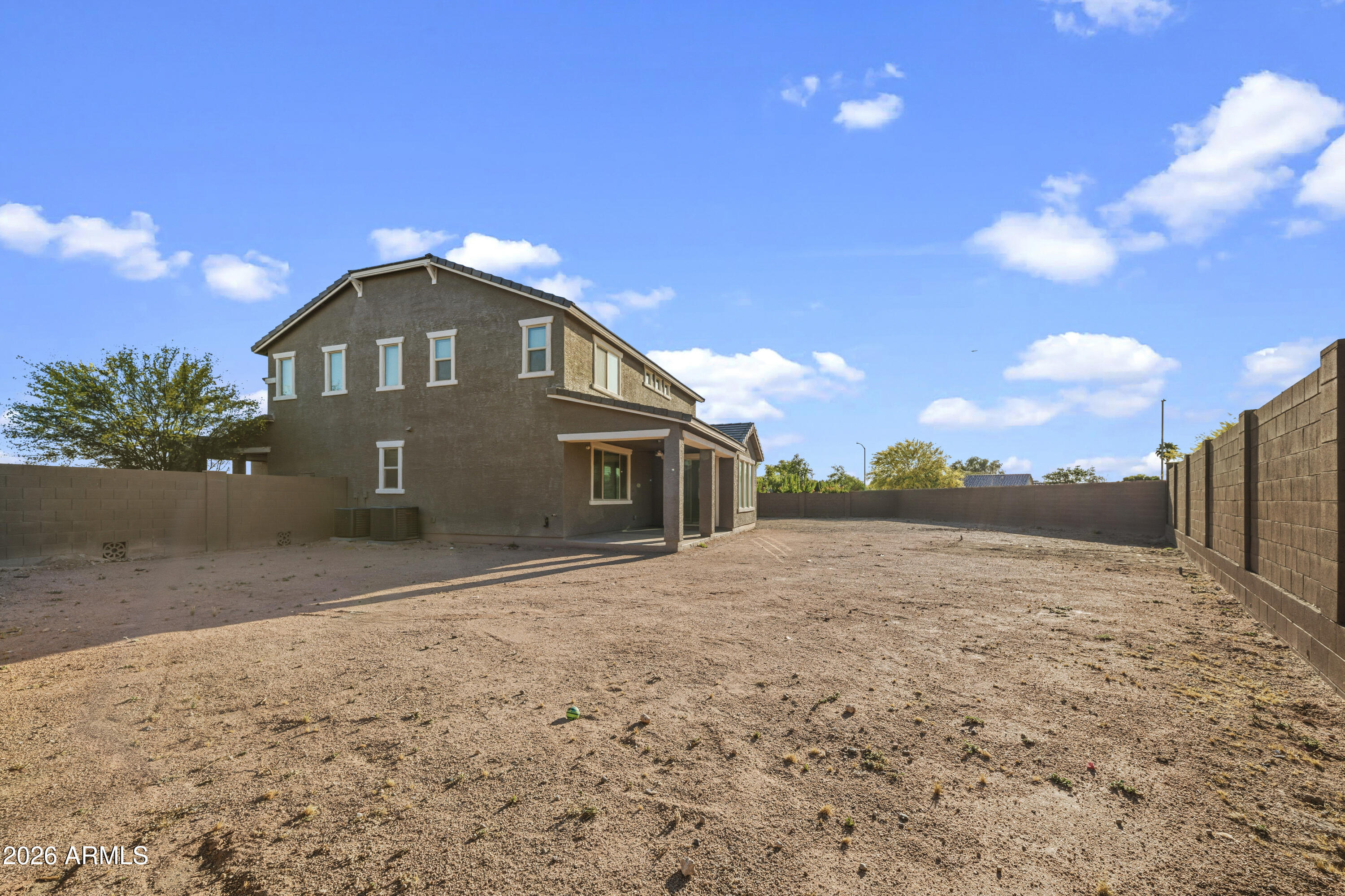 15754 West Madison Street Goodyear, AZ 85338 - Photo 34 of 35 a front view of a house with a yard