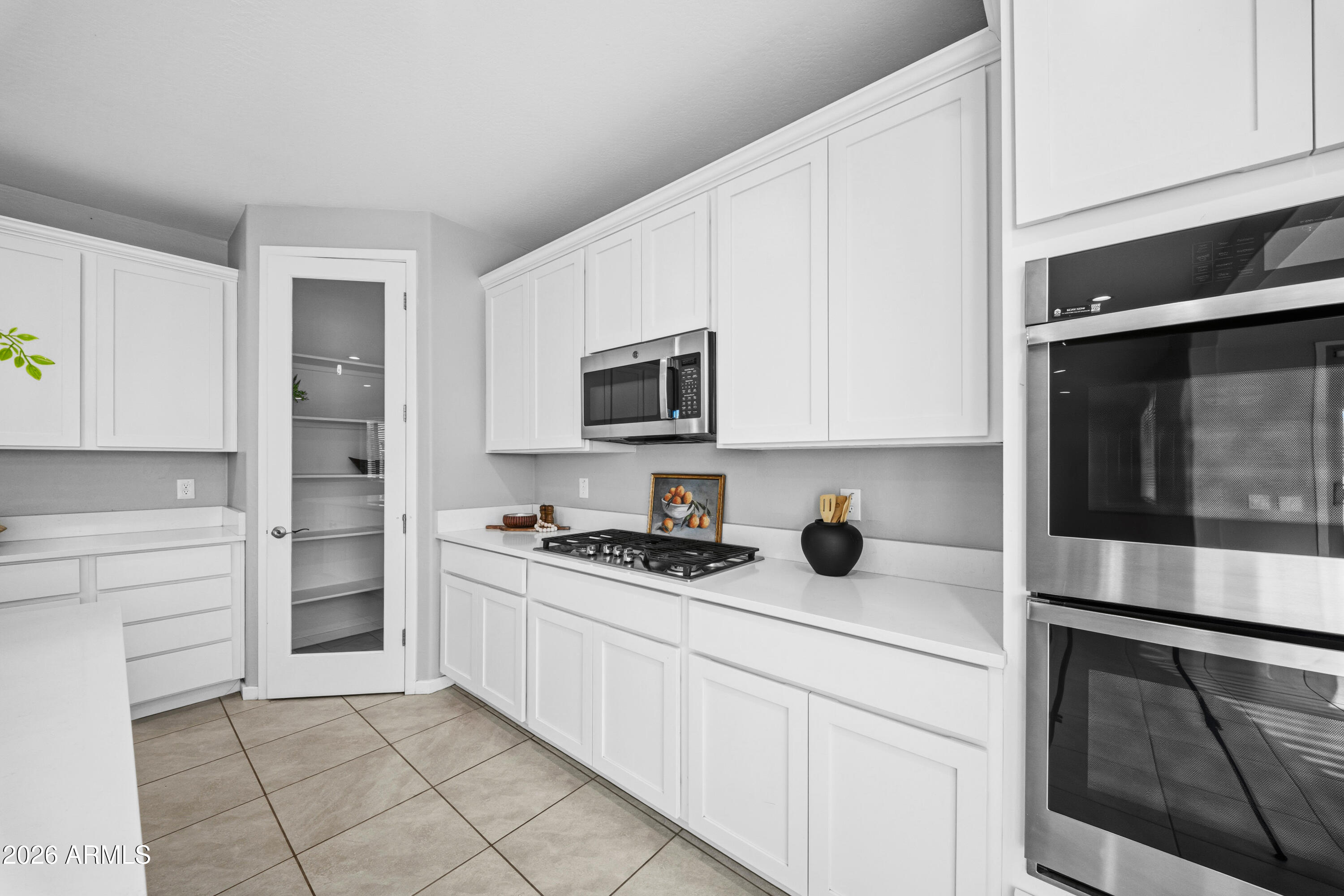 15754 West Madison Street Goodyear, AZ 85338 - Photo 8 of 35 a kitchen with a sink and cabinets