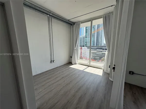 a view of wooden floor and windows in a room