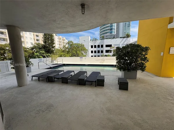 a living room with furniture and potted plants