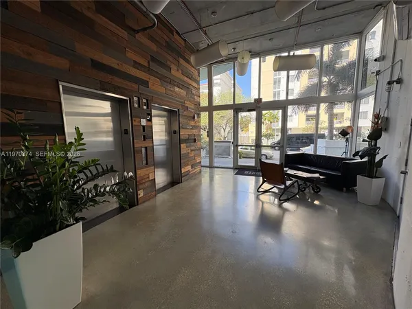 a lobby with furniture and floor to ceiling window