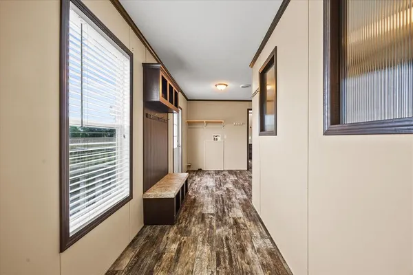 a view of a hallway with wooden floor and staircase