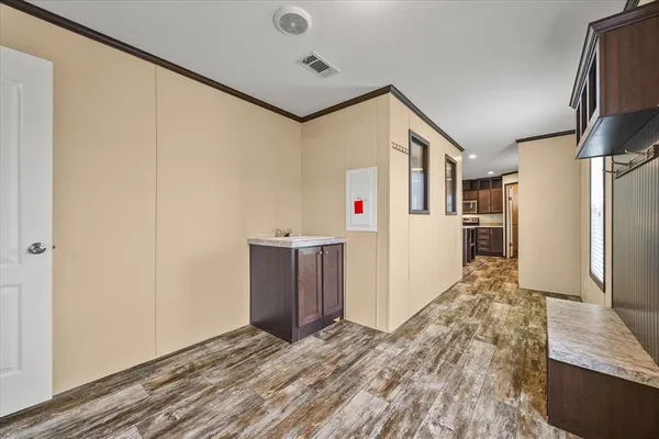 a view of a refrigerator in kitchen and wooden floor