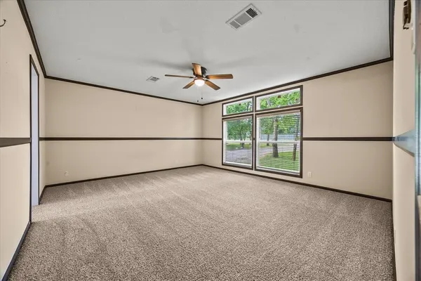 an empty room with windows and view of an empty room