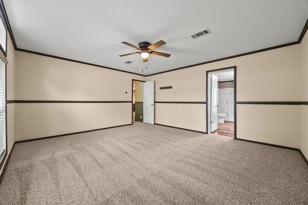 a view of a an empty room with a refrigerator