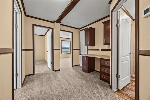 a view of kitchen with stainless steel appliances granite countertop cabinets and chandelier