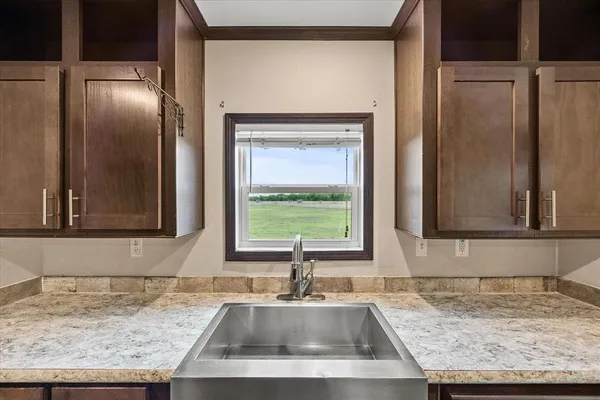 a sink with a granite countertop window