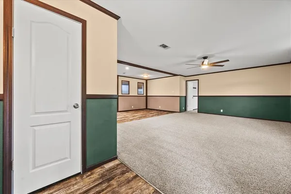 a view of a room with wooden floor and windows