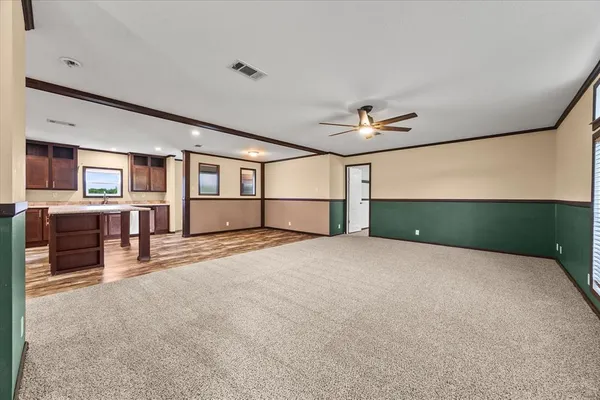 a view of a livingroom with furniture and a ceiling fan
