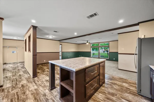 a kitchen that has a cabinets a sink and a refrigerator