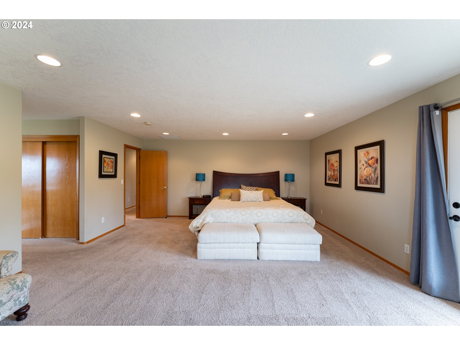 15680 Northeast Yamhill Road Yamhill, OR 97148 - Photo 27 of 47 a bedroom with a large bed and a wooden floor