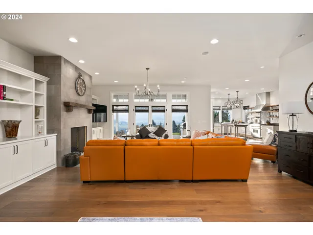a living room with furniture kitchen view and a fireplace