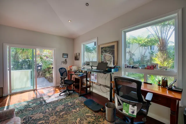 a living room filled with furniture and a large window