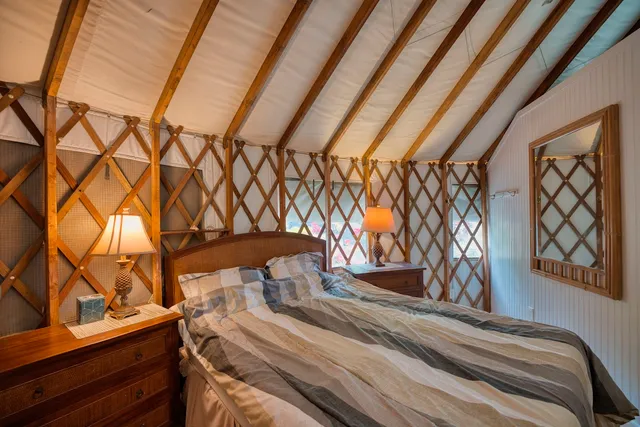 a view of a backyard with wooden fence