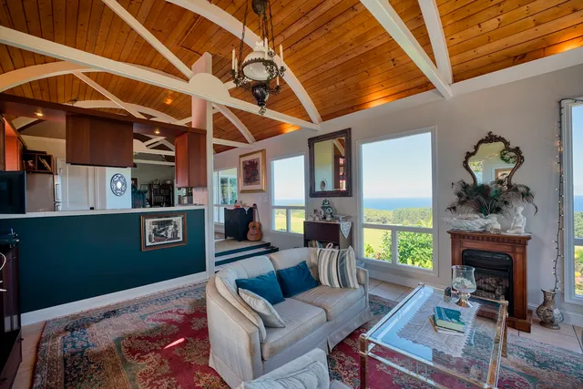 a living room with furniture a fireplace and a table