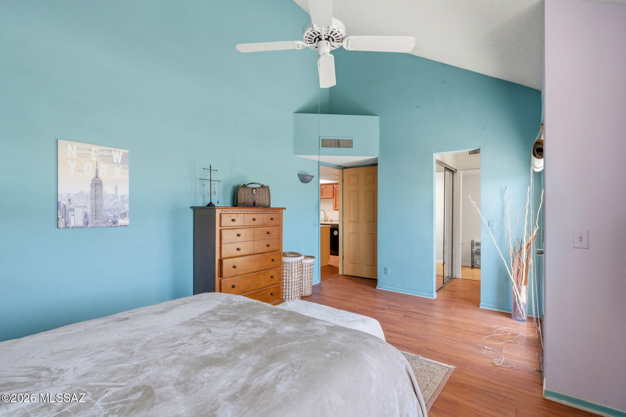 1200 East River Road, Unit G87 Tucson, AZ 85718 - Photo 16 of 30 a bedroom with a bed and wooden floor