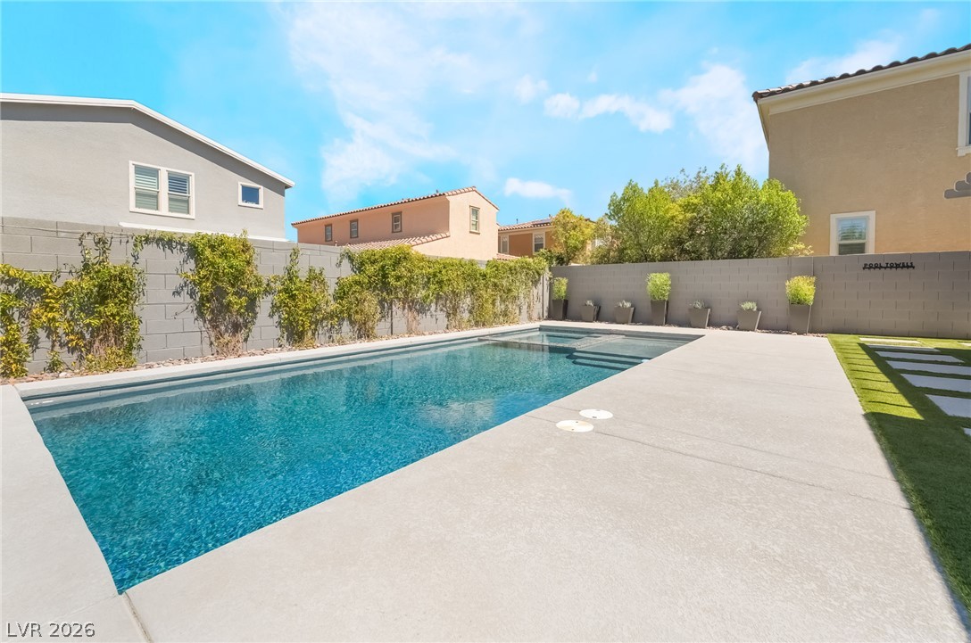 2166 Trivero Street Henderson, NV 89044 - Photo 39 of 61 A tranquil inground swimming pool with ample concrete decking creates a private outdoor oasis.